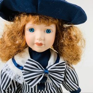 Porcelain Doll-16”- Blue with hat. And with stand.